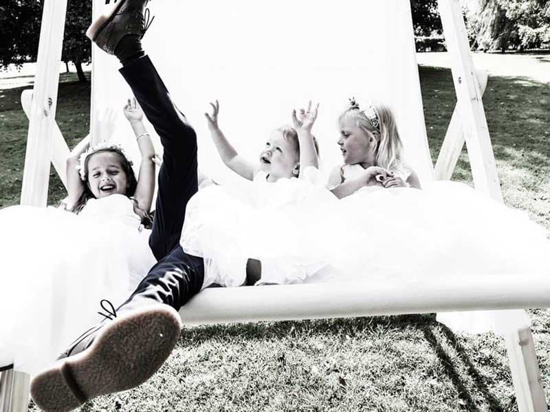 Guests posing in a giant deckchair at a wedding